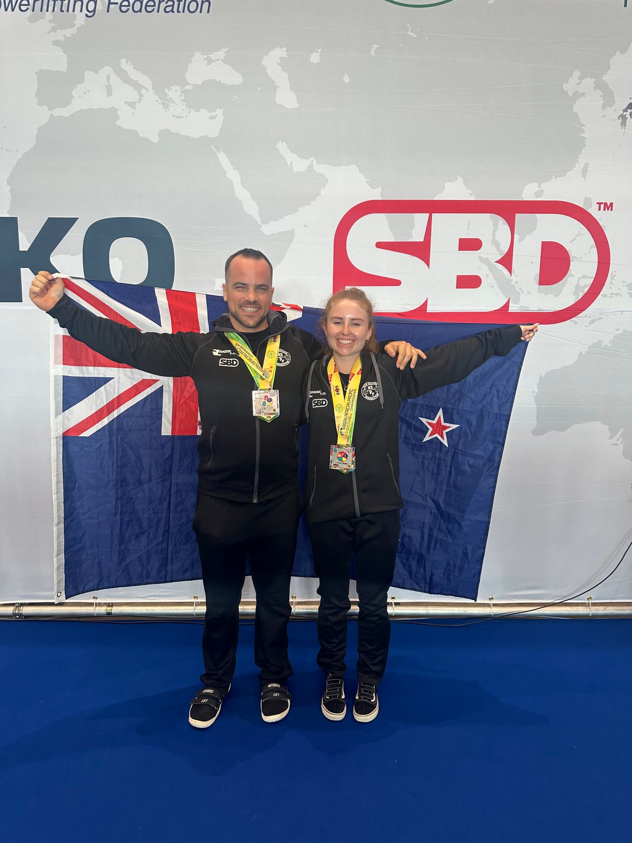 Richard Kerr-Phillips with a coached athlete at the 2025 Oceania Powerlifting Championships.